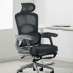 Chaise ergonomique grise et noire dans un bureau avec des murs et une table blanche.