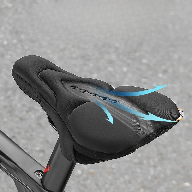 Housse de selle de vélo noir, avec des coussins en silicone pour absorber les chocs, installée sur un vélo noir.